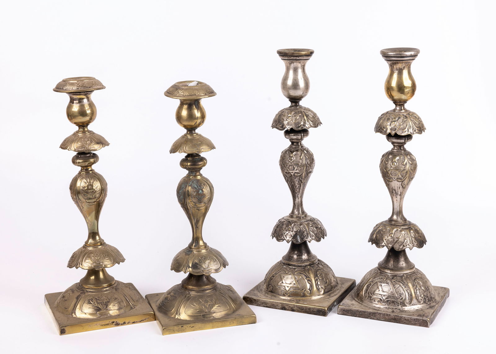 A GROUP OF TWO PAIRS OF SABBATH CANDLESTICKS. Poland, Late 19th century. Each in traditional form (1 of 1)
