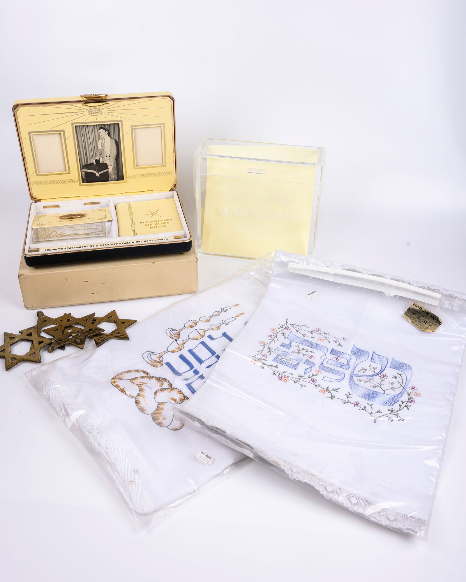 A GROUP OF JUDAICA. Including two new challah covers, a matzah box, an unused “my bar mitzvah (1 of 1)