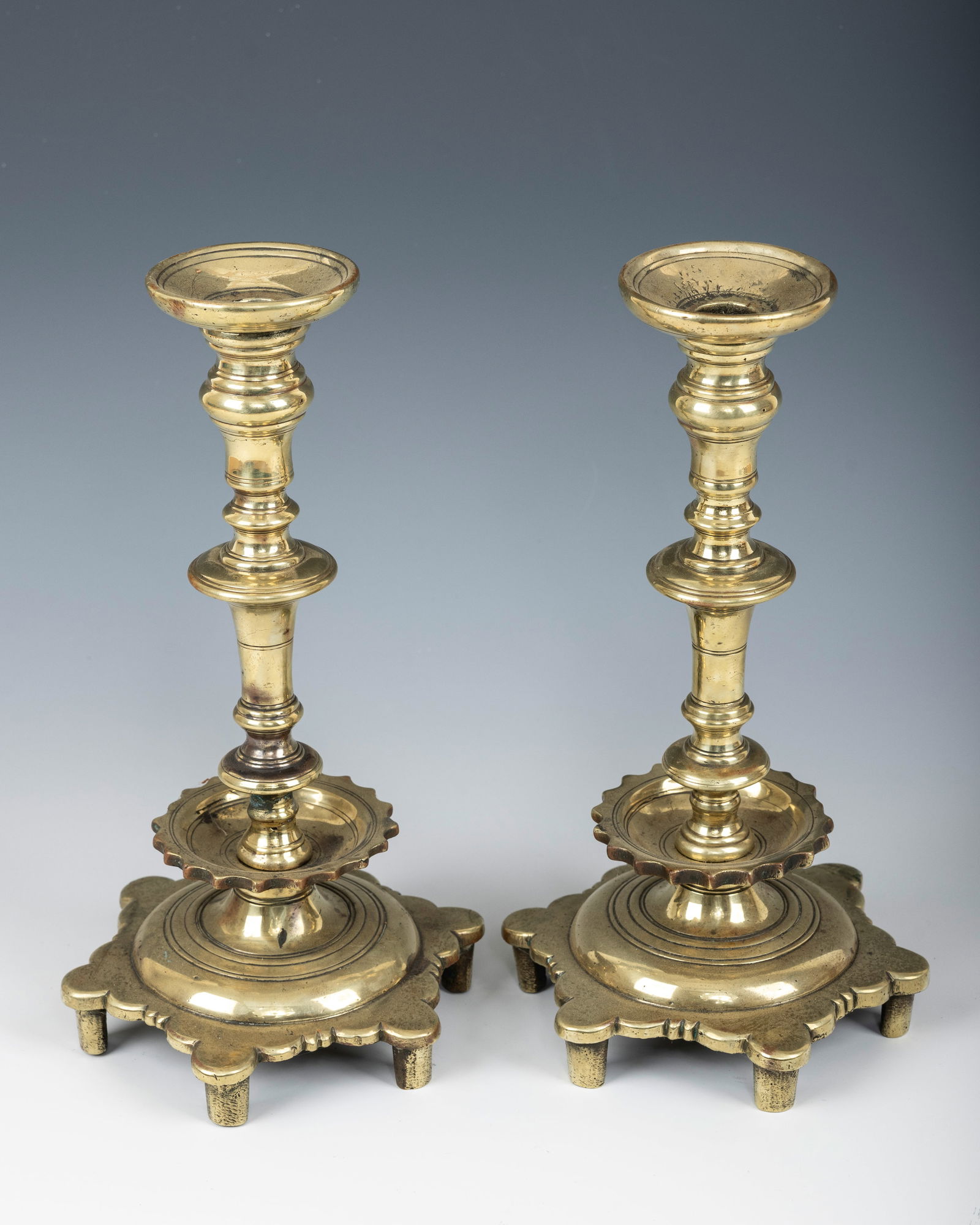 A PAIR OF EARLY SABBATH CANDLESTICKS. Russia or Poland, 18th century. On six feet with a baluster (1 of 1)