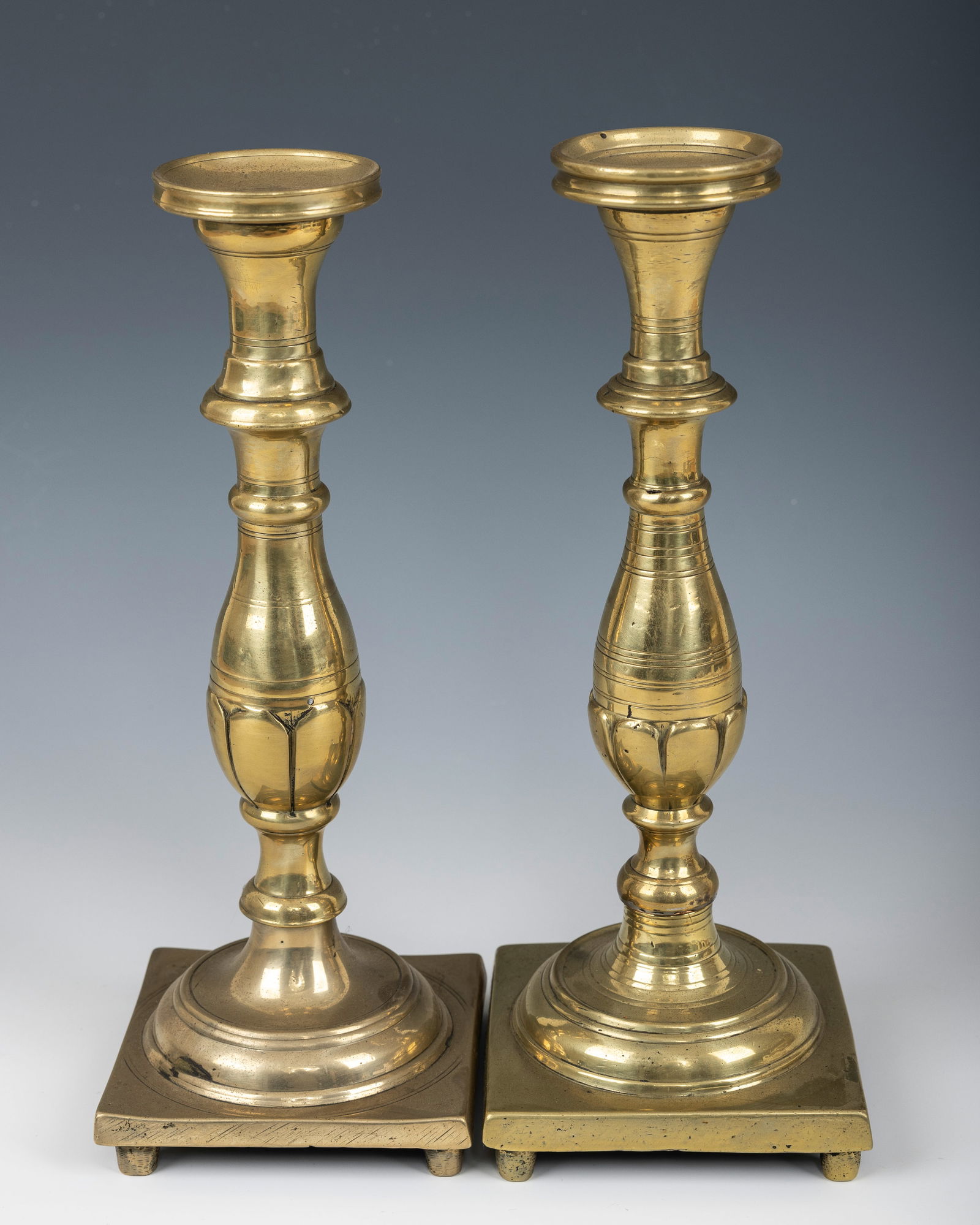 A PAIR OF EARLY SABBATH CANDLESTICKS. Russia or Poland, 18th century. On a square base with a (1 of 1)