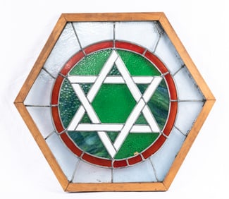 A STAINED GLASS JEWISH STAR FROM A SYNAGOGUE. American, c. 1920. In an octagonal wooden frame. 28
