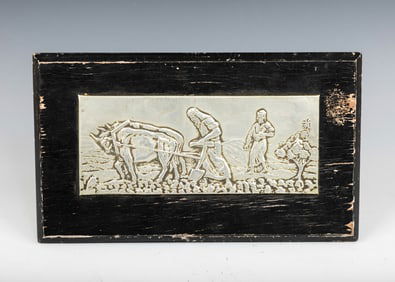 A SILVERED PLAQUE OF A PLOWMAN. Jerusalem, c. 1920. Probably by the Bezalel school. Mounted on wood.
