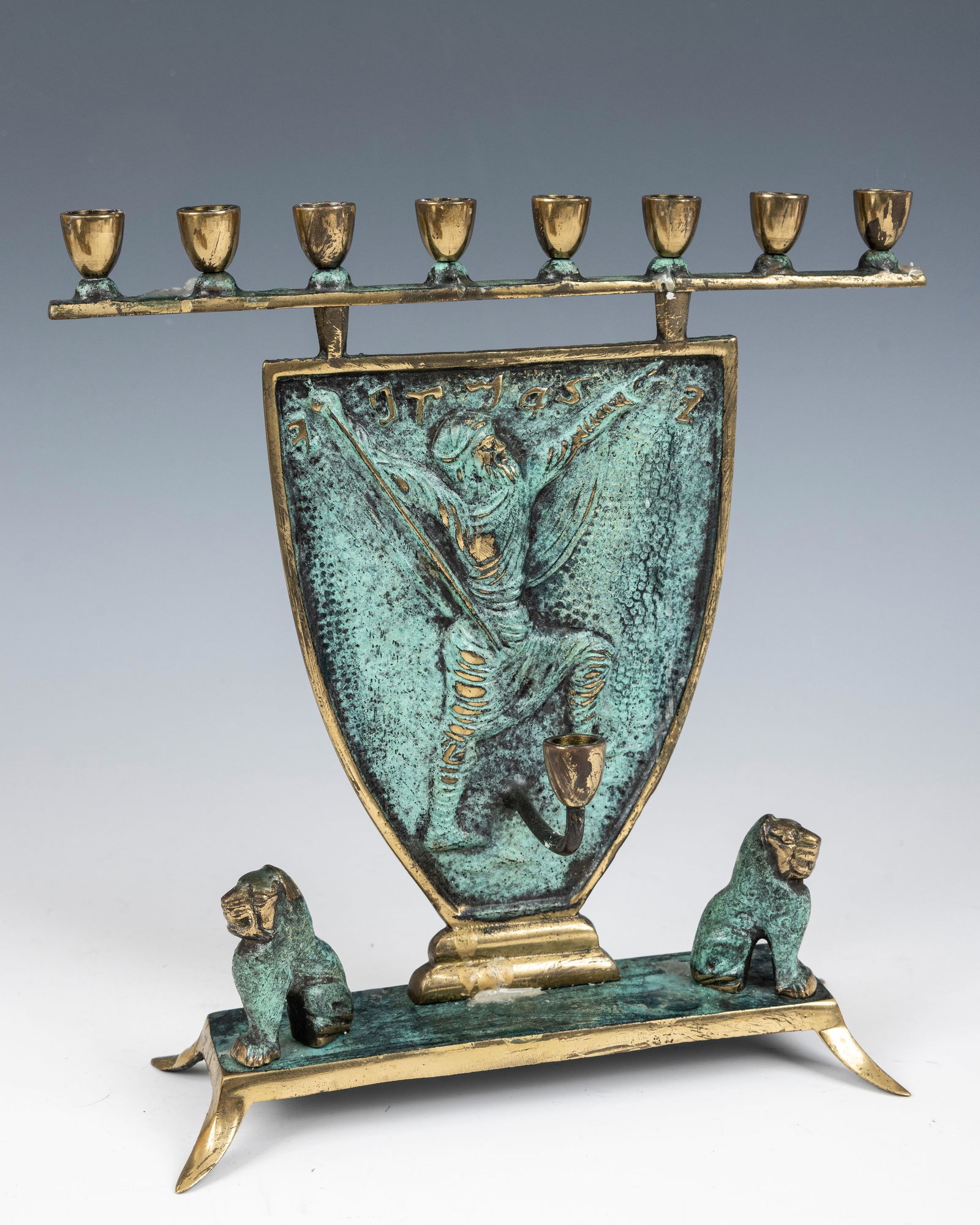 A GREEN PATINATED BRASS MENORAH BY F.J. KORMIS. Israel, c. 1950. Designed by the English sculptor (1 of 1)
