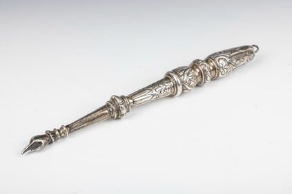 A SILVER TORAH POINTER. Vienna, c. 1880. Hand chased with baroque designs. With the original hand
