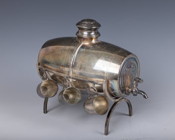 A SILVER PLATED WINE BARREL. Israel, c. 1960. In barrel form. With a fountain and six wine cups.