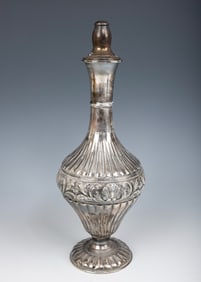 A STERLING SILVER WINE BOTTLE GIVEN BY THE SATMAR REBBETZIN. New York, c.1980. Traditional form.