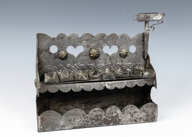 A TIN HANUKKAH LAMP. German or Dutch, c. 1800.With a cut out back plate decorated with hearts and a