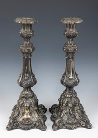 A PAIR OF SILVER CANDLESTICKS. Germany, c. 1890. The bases are embossed with floral designs. The