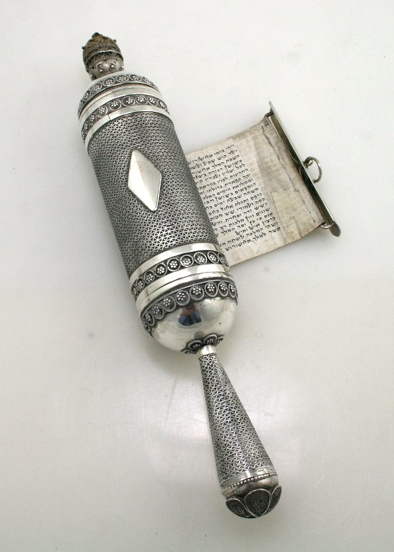 A STERLING SILVER MEGILLAH CASE: A A STERLING SILVER MEGILLAH CASE WITH MEGILLAH.Israel, c. 1950. Silver case with filigree applied wirework. and a parchment megillah inside. Estimate $800 - 1200