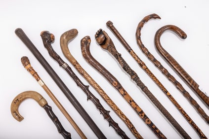 AN GROUP OF TEN CARVED WOODEN CANES AND WALKING STICKS. Hand carved of different woods including