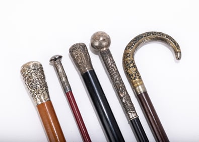 A GROUP OF FIVE SILVER HANDLED DRESS CANES. India and Middle Eastern, c. 1900. Of various forms