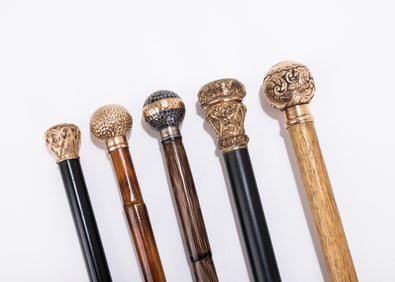 A GROUP OF FIVE GOLD FILLED/GOLD PLATED HANDLED DRESS CANES.