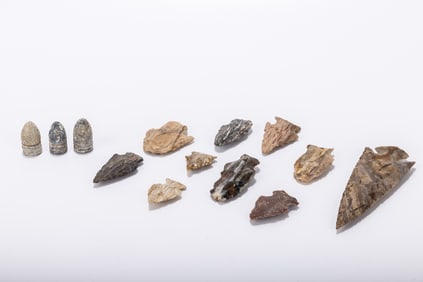 A COLLECTION OF AMERICAN INDIAN ARROWHEADS AND THREE CIVIL WAR BULLETS. United States, c. 1860.