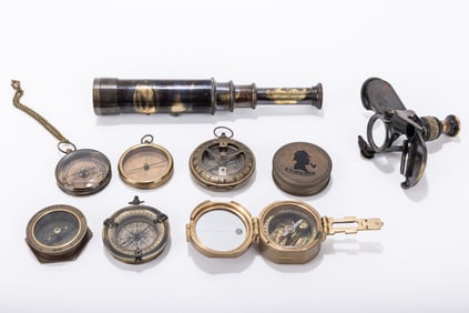 A GROUP OF SEVEN BRASS COMPASSES AND A TELESCOPE. 20th century.&nbsp; A variety of ages. Some