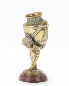 AN ANTIQUE BRONZE FIGURINE. France, c. 1900. Of a young man carrying a vase on his back. 6.5â€