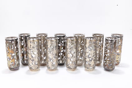 A GROUP OF 12 STERLING SILVER OVERLAY DRINKING GLASSES. Probably South American, c. 1950. Decorated