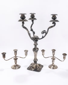 A GROUP OF SILVER CANDLESTICKS. Including a German silver three light candelabra