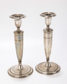 A PAIR OF STERLING SILVER CANDLESTICKS BY TIFFANY AND COMPANY.