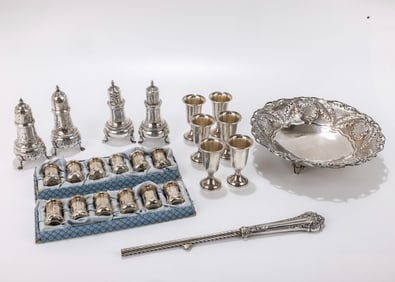 A GROUP OF STERLING SILVER TABLEWARE. Including 12 small salt shakers, 4 large ones, a bowl, six