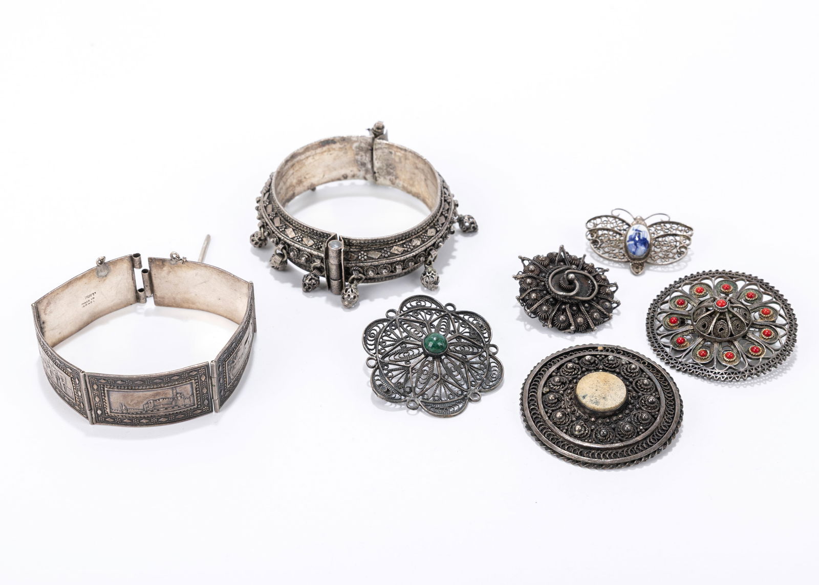 A GROUP OF STERLING SILVER JEWELRY. Including two bracelets, five brooches and a heart necklace. (1 of 1)