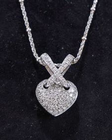 AN 18K AND DIAMOND PENDANT WITH A 14k CHAIN. Italian, modern. The chain is 14K and weighs 4.3gm and