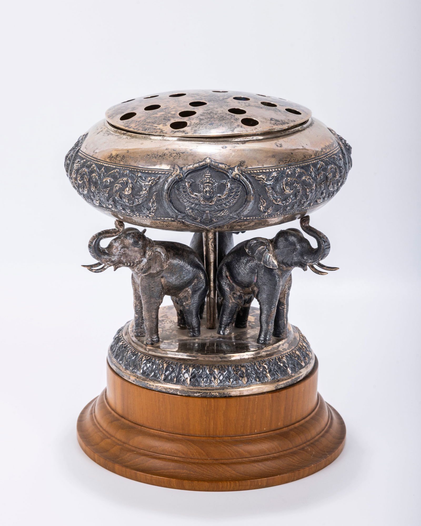 A LARGE SILVER AND WOOD FIGURAL INCENSE BURNER. India, c. 1900. On a wood base with three elephants (1 of 1)