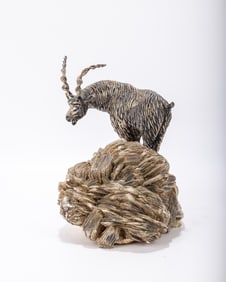 A SOLID SILVER MOUNTAIN GOAT ON A MICA BASE. 8.5" TALL. SIGNED