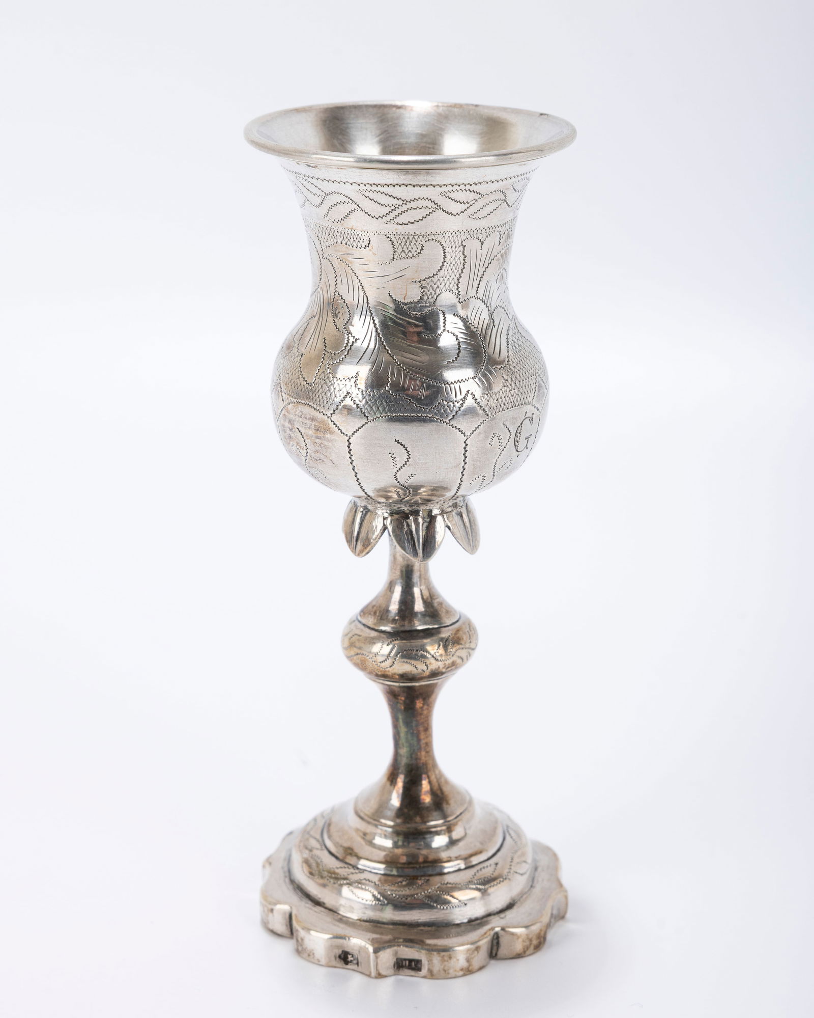 A SILVER KIDDUSH GOBLET. Vilna, 1879. On a stylized base with knobbed stem and skirted decoration. (1 of 6)