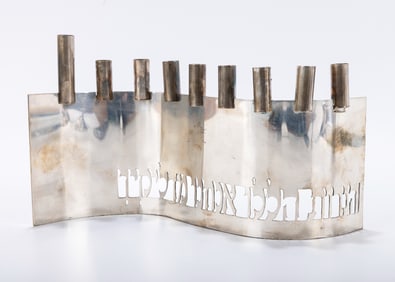 A HANDMADE STERLING SILVER HANUKKAH MENORAH. Israel, c. 1985. Wavy lattice work base with cut out