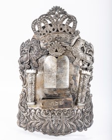 A SILVER TORAH SHIELD. Poland, 19th century. Decorated with an engraved Decalogue, two lions and a