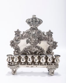 A SILVER HANUKKAH LAMP BY REINER. Warsaw, 1873. N four feet with eight oil holders. The backplate is