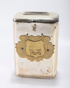 A SILVER PLATED CHARITY BOX. Continental, 20th century. With a handle, a money slot and an applied