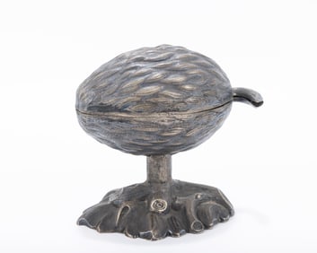 A SILVER ETROG CONTAINER. Germany, c. 1870. On a leafy base with a stem that attaches to the upper