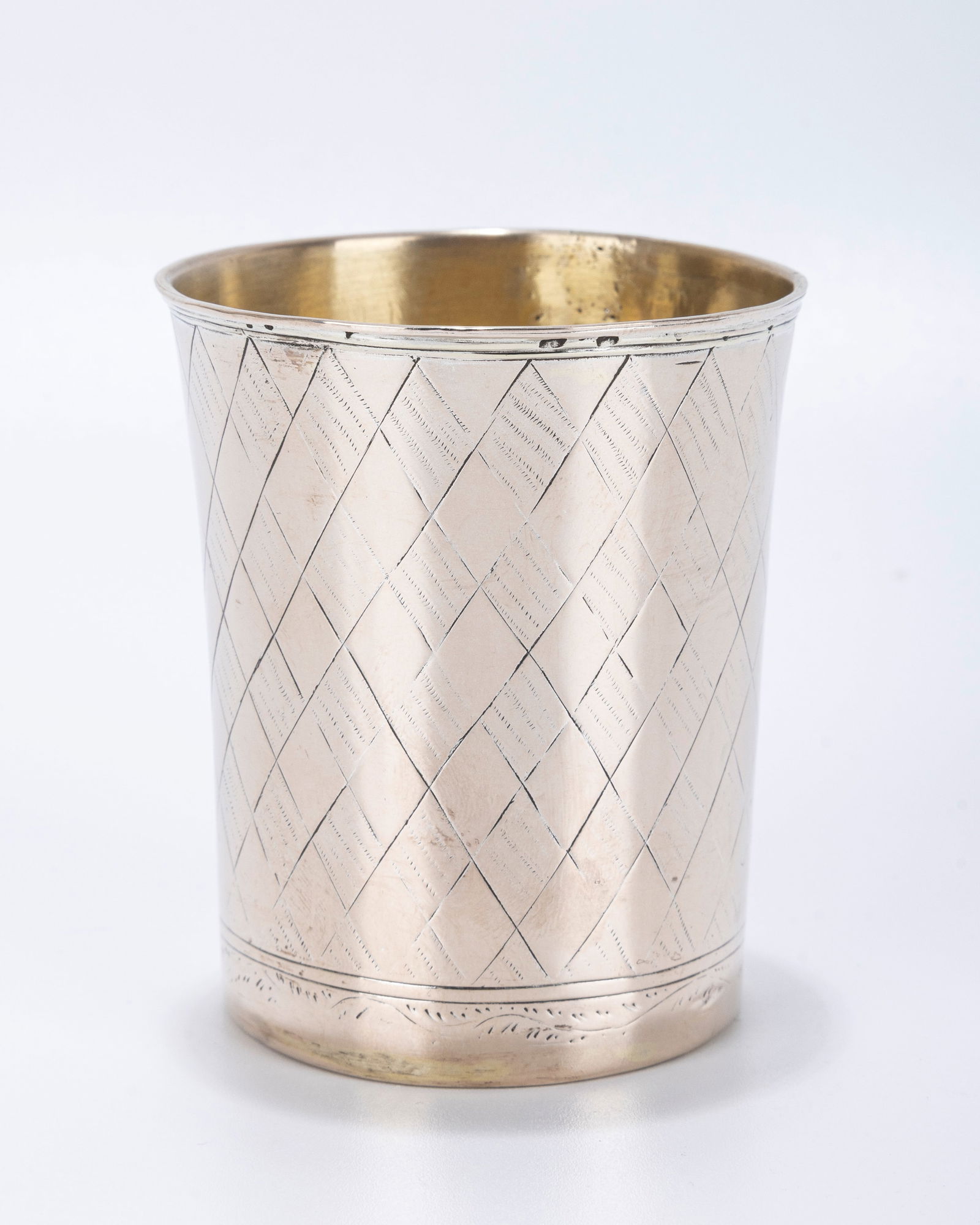 AN EARLY SILVER KIDDUSH CUP. Poland, 1844. Diamond shaped engravings on the body. With the former (1 of 3)