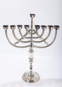 AN EXCEPTIONAL SILVER HANUKKAH MENORAH. Italy, 19th century. On a round base with eight branched