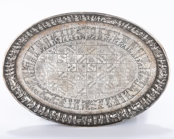 AN EARLY PERSIAN OVAL AMULETIC TRAY. Persia, c. 1900. Hand chased and engraved with festive figures