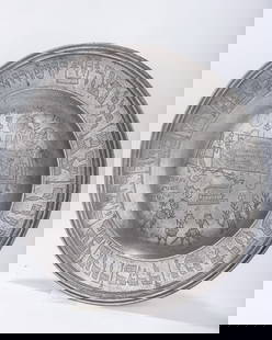 A LARGE PEWTER SEDER TRAY. Germany, 1808. The center is engraved with a seder scene at the table.: A LARGE PEWTER SEDER TRAY. Germany, 1808. The center is engraved with a seder scene at the table. The outer perimeter is engraved with the order of the seder.14.7" wide.