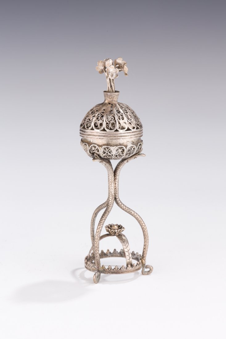A SILVER SPICE TOWER. Ukraine, Early 19th century. On r: A SILVER SPICE TOWER. Ukraine, Early 19th century. On round base with three snake shaped stems that connect to filigree spherical upper section. 5.1” tall. Estimate $3,000 – 5,000