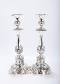 A PAIR OF EXCEPTIONAL SILVER SABBATH CANDLESTICKS  Minsk, 1880. Each on a stylized square base,