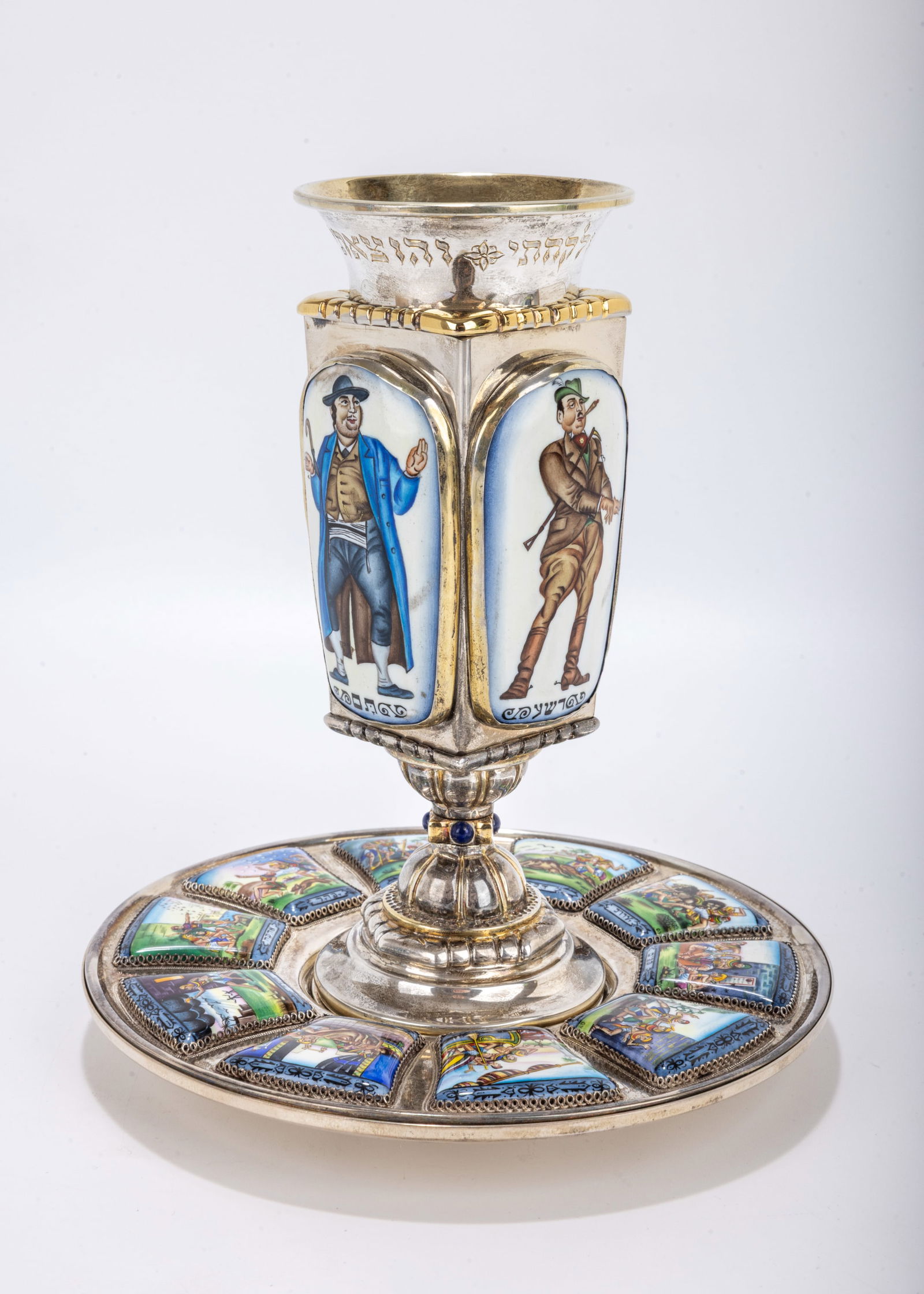 A STERLING SILVER AND ENAMEL PASSOVER GOBLET BY YAAKOV DAVIDOFF. Israel, c. 2005. Hand crafted. The: A STERLING SILVER AND ENAMEL PASSOVER GOBLET BY YAAKOV DAVIDOFF. Israel, c. 2005. Hand crafted. The plate is decorated with the ten plagues set on a hand hammered base. The upper portion is decorated