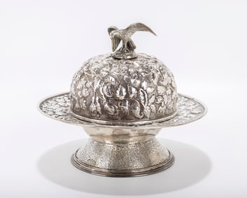 A STERLING SILVER COVERED DISH BY KIRK.  Hand embossed in repousee design.  6.7 inches wide. 13.64