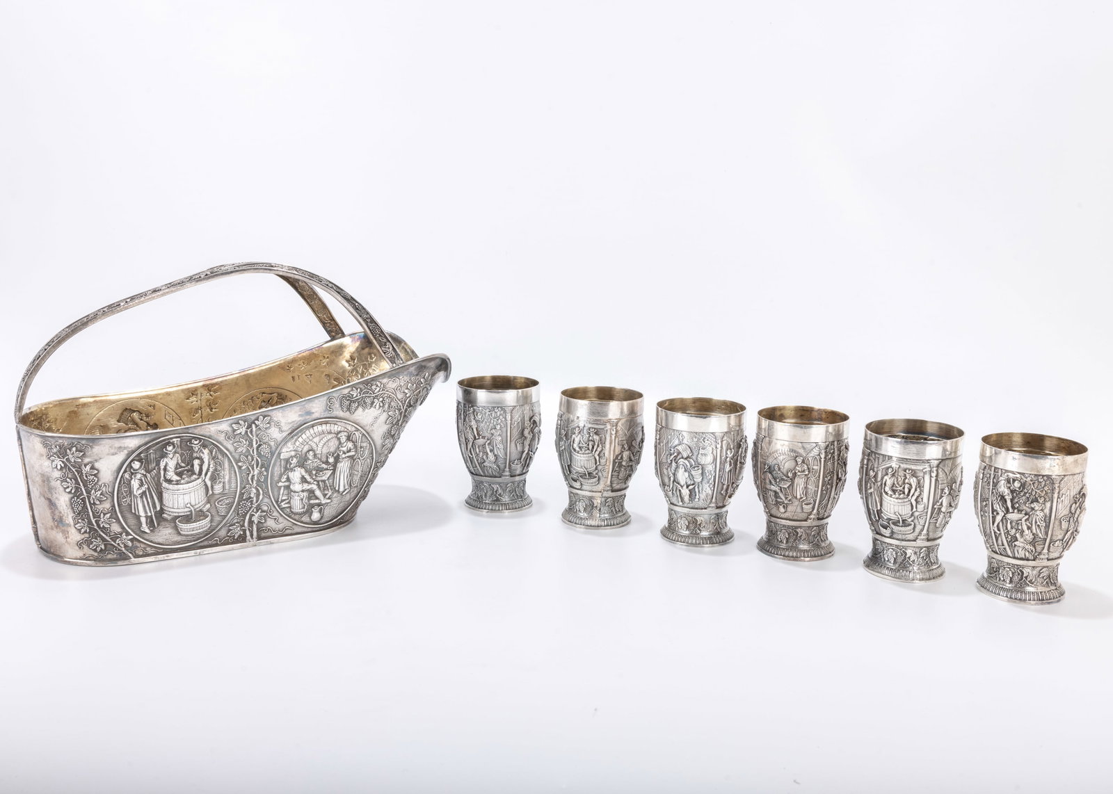 A DUTCH SILVER WINE CUP SET. The Netherlands, c. 1920. Each cup is 3 inches tall. The holder is 10: A DUTCH SILVER WINE CUP SET. The Netherlands, c. 1920. Each cup is 3 inches tall. The holder is 10 inches x 4 inches. Total weight is 40.41 ozt.