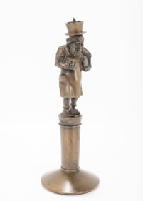 A BRONZE ANTISEMITIC FIGURINE CANDLE HOLDER. Stuttgart, 1880. On a round base with a Jewish figure