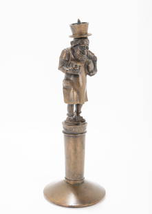 A BRONZE ANTISEMITIC FIGURINE CANDLE HOLDER. Stuttgart, 1880. On a round base with a Jewish figure: A BRONZE ANTISEMITIC FIGURINE CANDLE HOLDER. Stuttgart, 1880. On a round base with a Jewish figure on a pedestal. 10" tall.