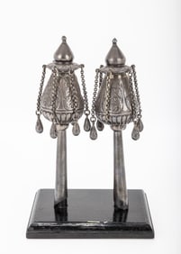 A PAIR OF SILVER TORAH FINIALS. Persian, 19th century. The upper portion chased with floral patterns