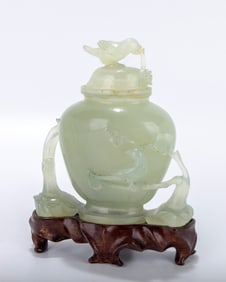 A JADE SCULPTURE. China, 19th century. On a wood base. In the shape of an urn. Apparently repaired