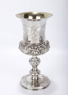 A MONUMENTAL SILVER KIDDUSH GOBLET. Warsaw, 19th century. On a round base that is engraved with a: A MONUMENTAL SILVER KIDDUSH GOBLET. Warsaw, 19th century. On a round base that is engraved with a geometrical design. A Baluster shaped stem and an outward tapering embossed upper portion. Traces of i