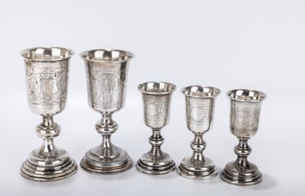 A GROUP OF FIVE SILVER KIDDUSH GOBLETS. Warsaw, c. 1870. Each on a round base and in similar design.