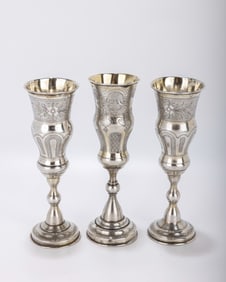 A GROUP OF THREE SILVER CHAMPAGNE FLUTES. On round stems  with a bright cut engine turned engraving