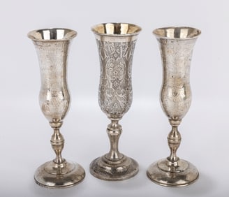 A GROUP OF THREE SILVER CHAMPAGNE FLUTES. On round stems  with a bright cut engine turned engraving